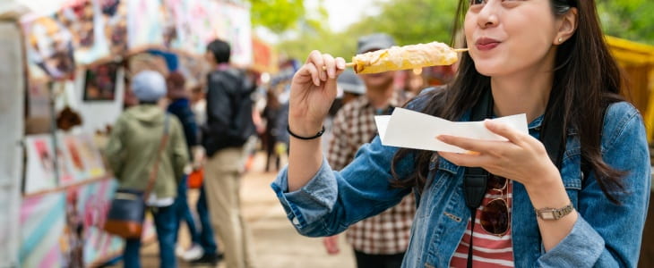 Woman sampling food at a food and wine festival